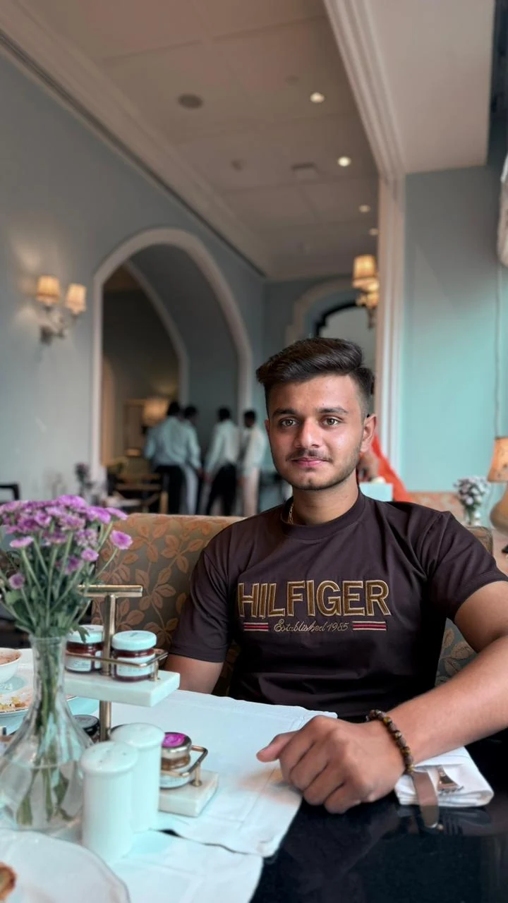 Pratham seated in a café